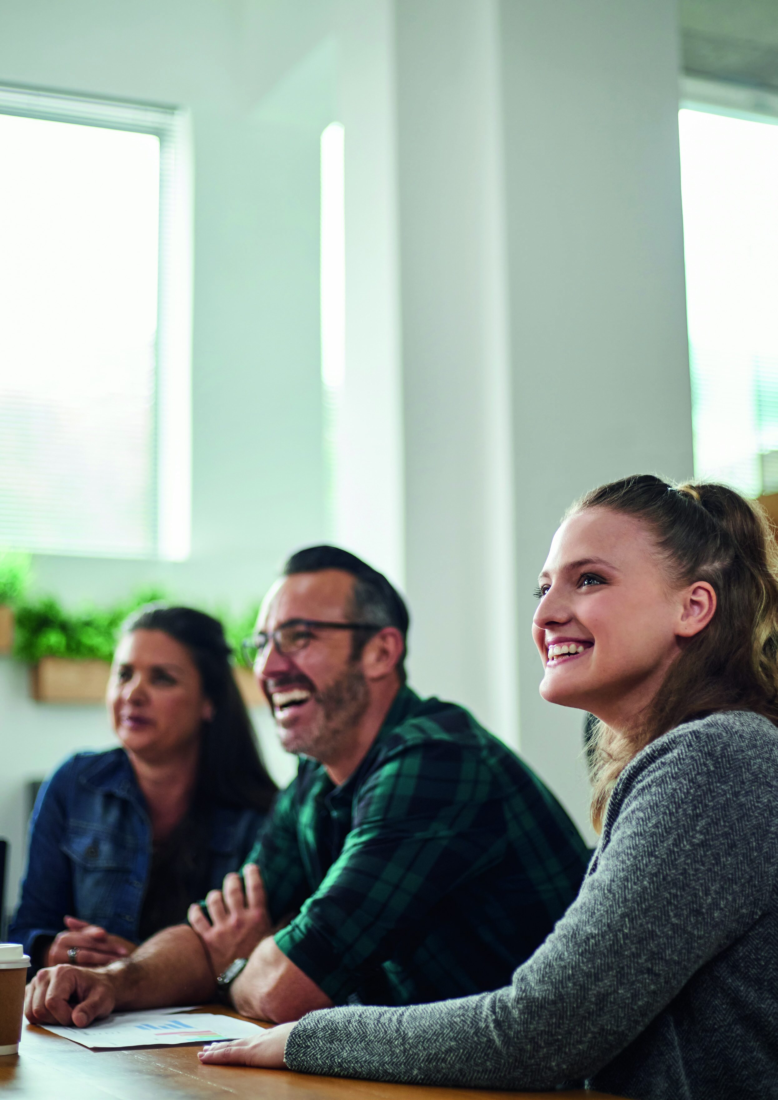 Colleagues smiling at a meeting