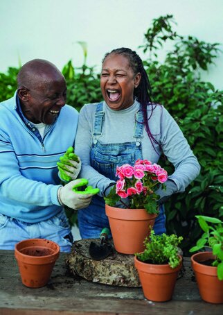 Couple having fun gardening together outdoors