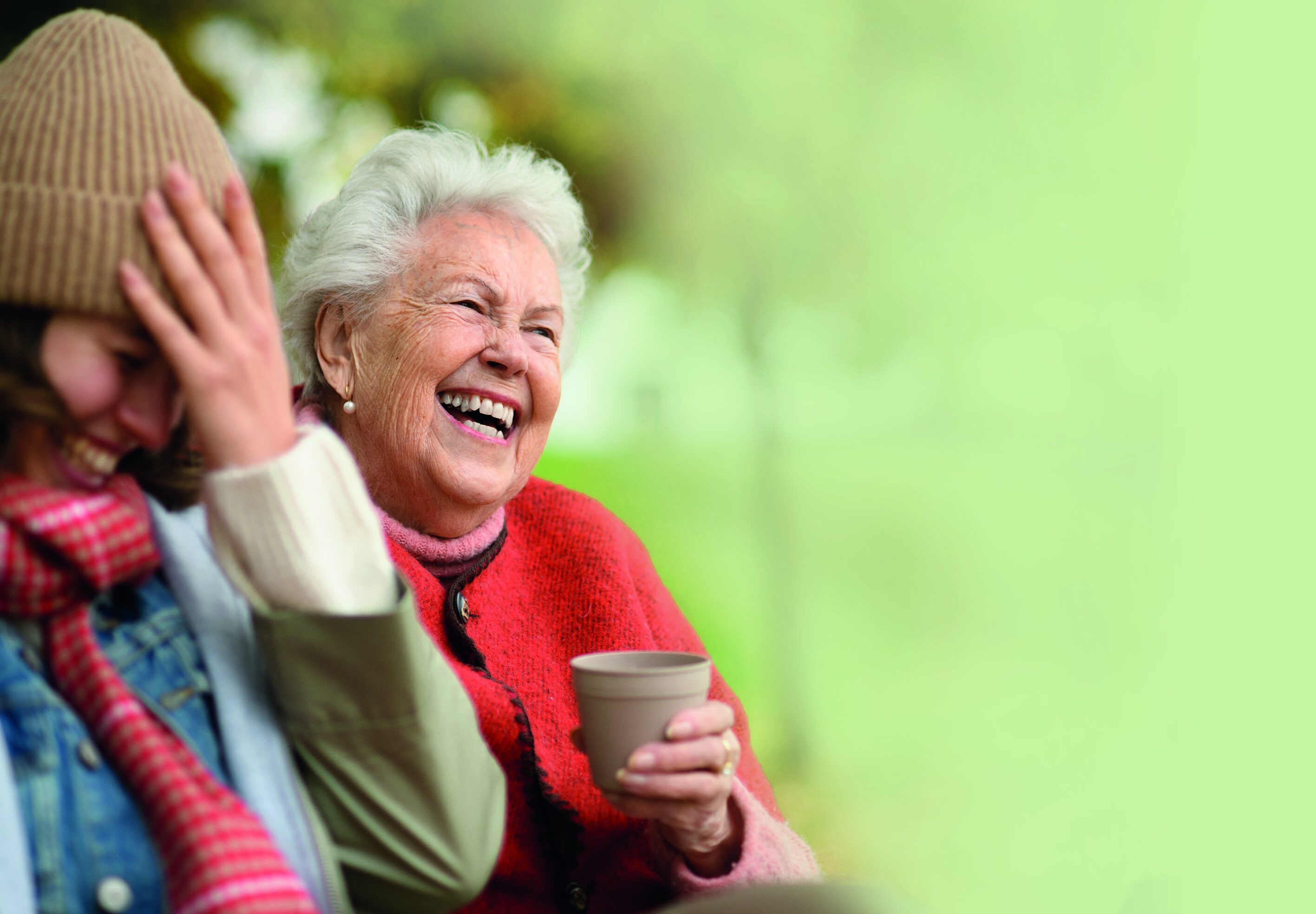 An elderly person talking to their child or carer