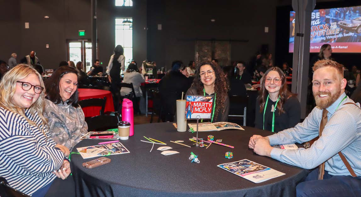 Attendees collaborating at a table during a breakout session