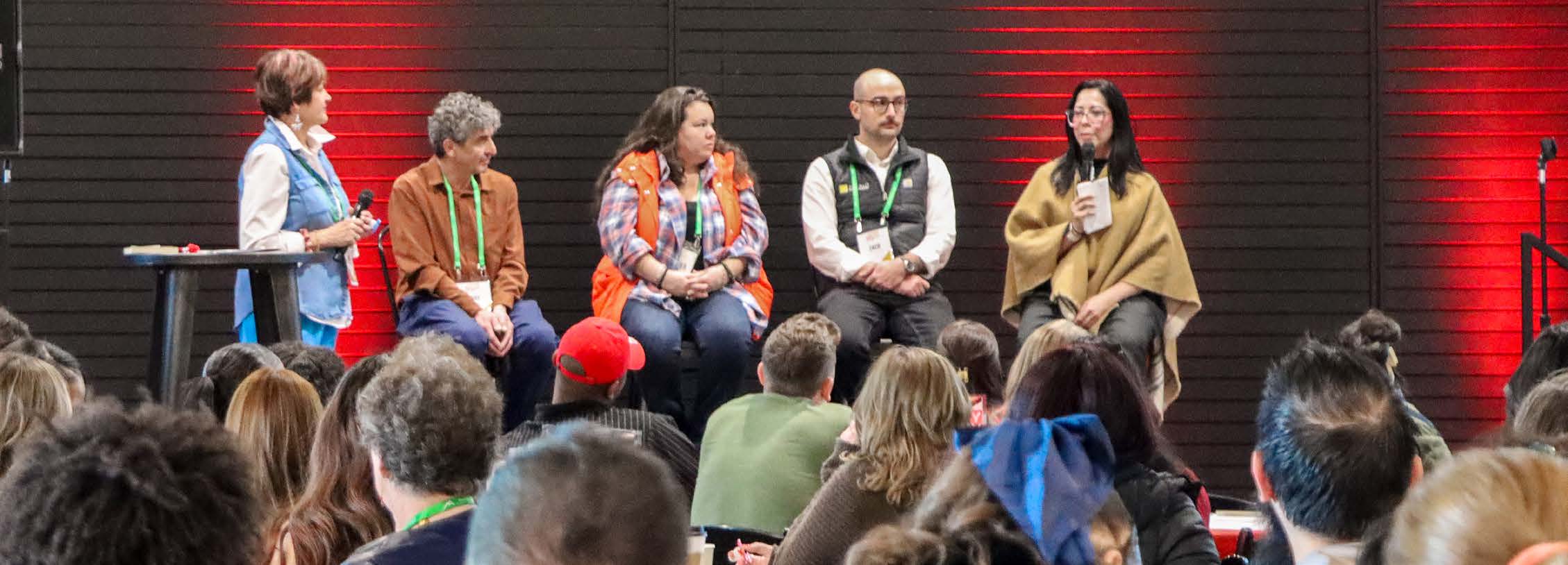 Panel of industry leaders speaking on stage