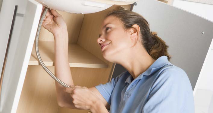 Maintenance worker repairing sink plumbing