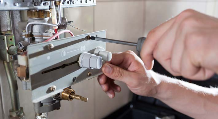HVAC technician checking pressure gauges