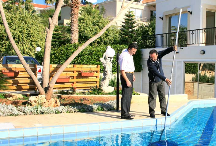 Maintenance worker by outdoor apartment pool