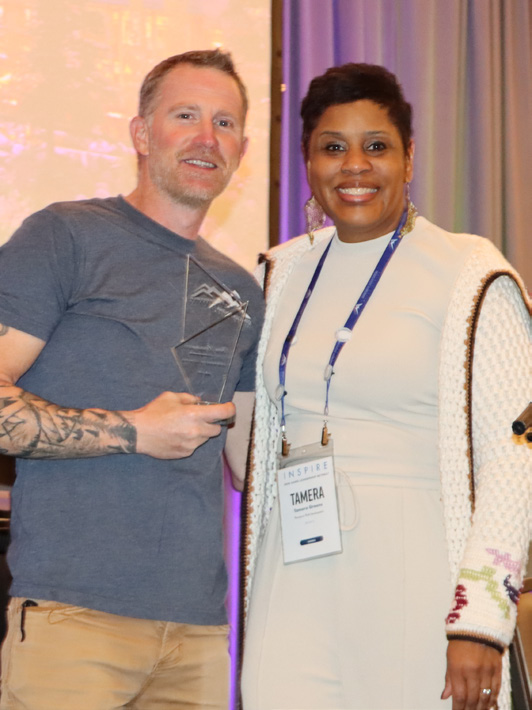 Chris Pennington standing with an event attendee