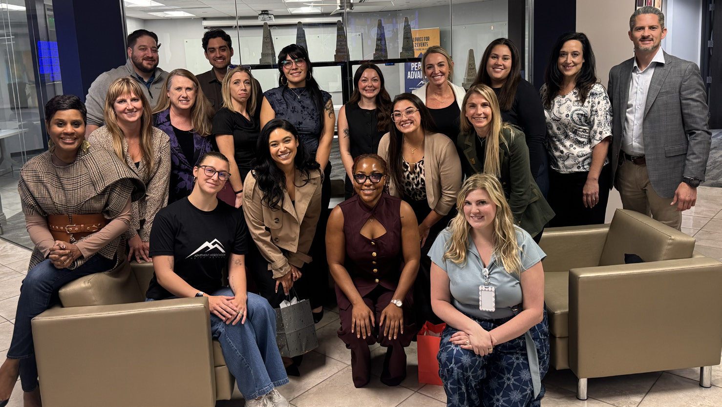 A group of AAMD M.I.N.D. mentors and mentees gathered in a lounge.