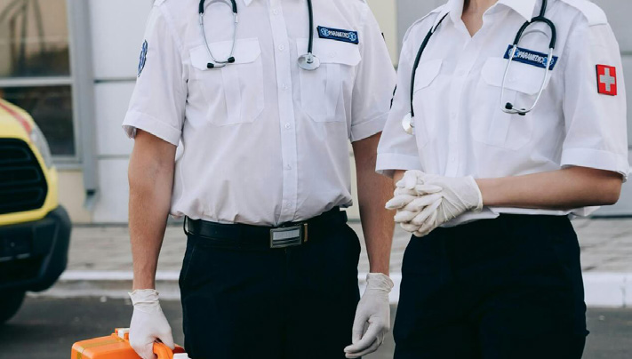 Two workers wearing safety gloves