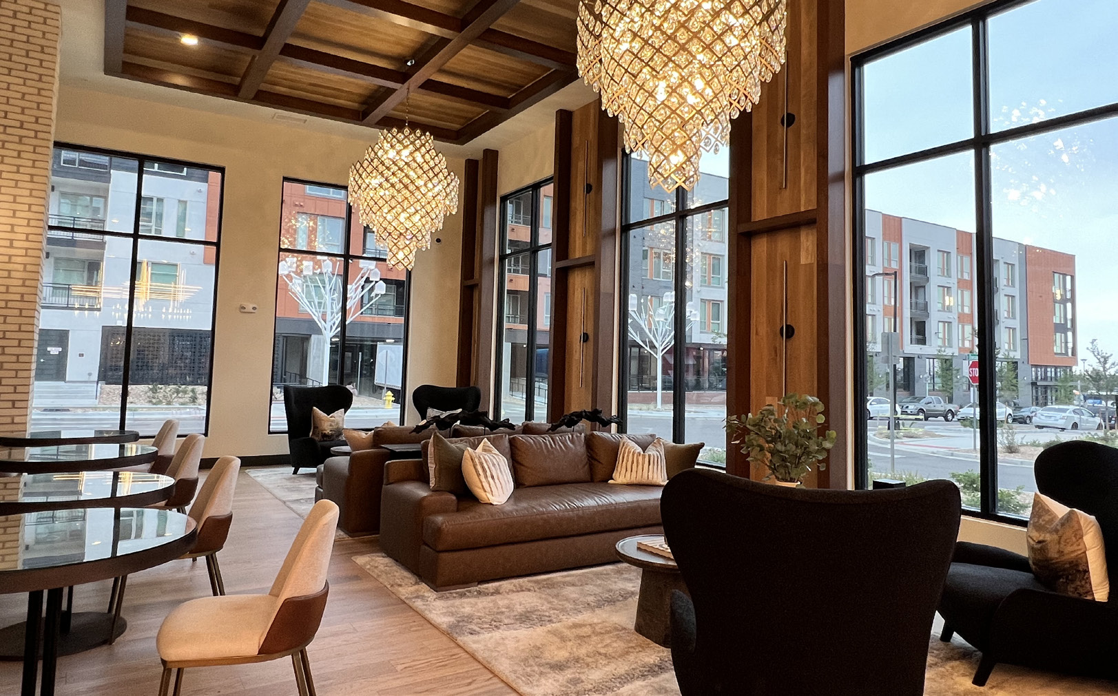 Community lounge with large windows, wood accents and seating