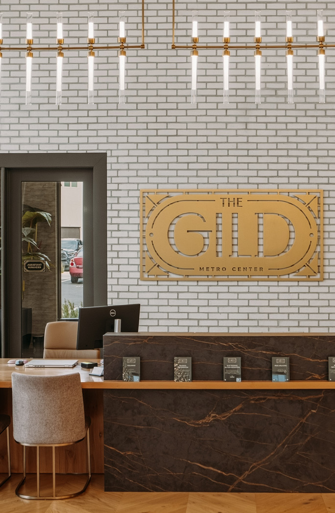 The Gild reception desk and gold wall sign