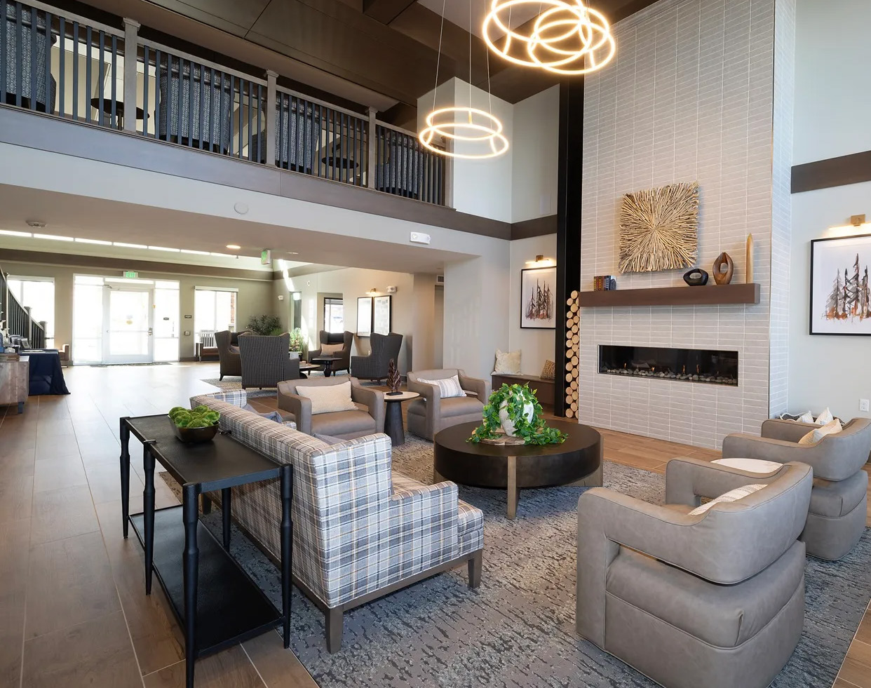 Community lounge with a fireplace, seating and pendant lighting