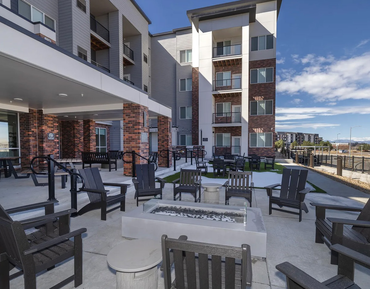Outdoor courtyard with seating and a fire feature