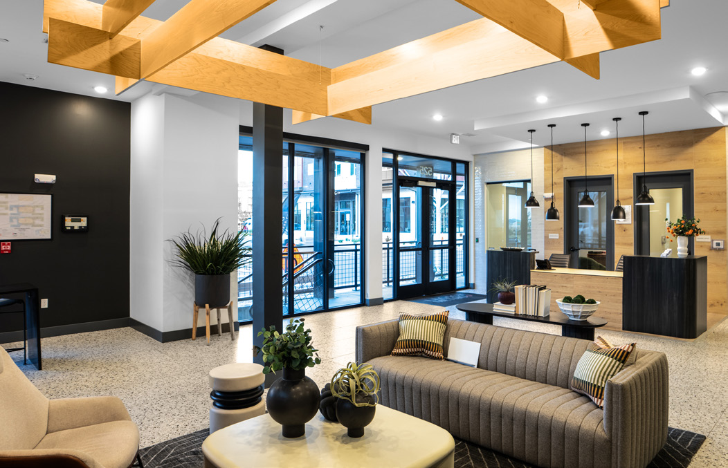 Community lounge with seating and decorative wood ceiling beams