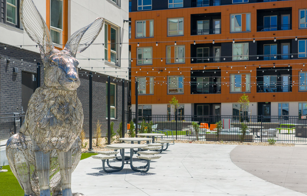 Rabbit sculpture and picnic tables in a courtyard