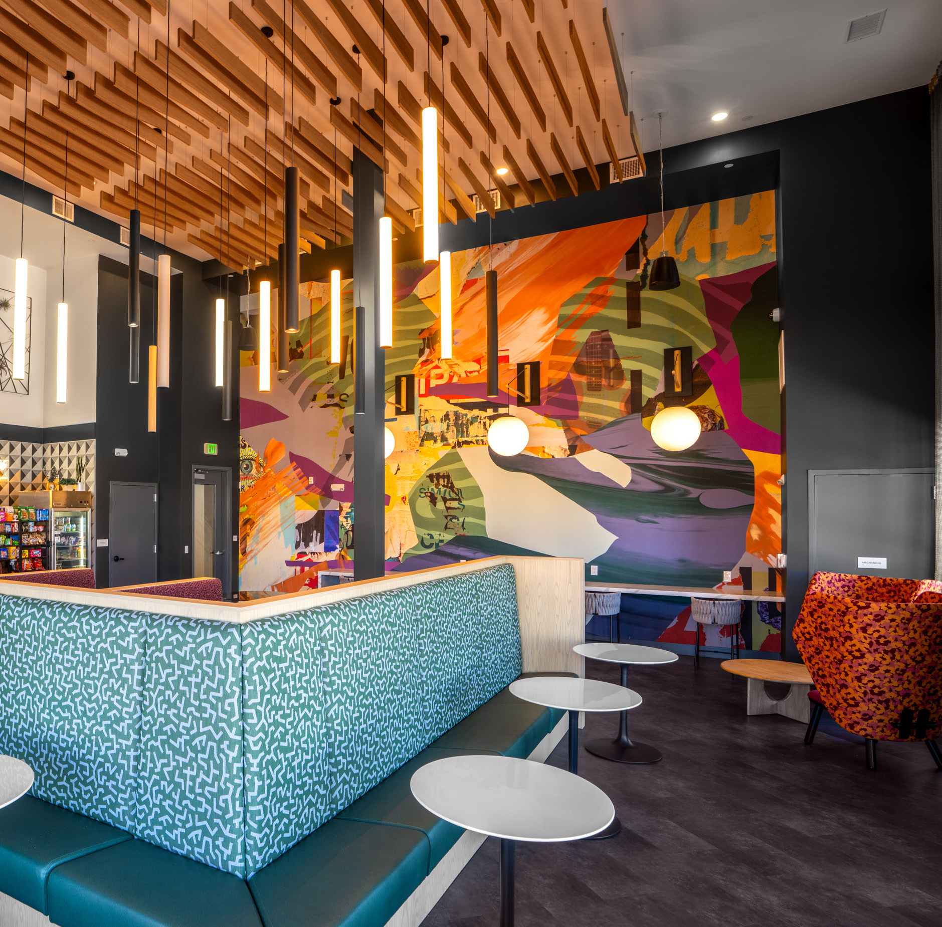 Caf&eacute; 525 interior with a colorful mural and turquoise seating