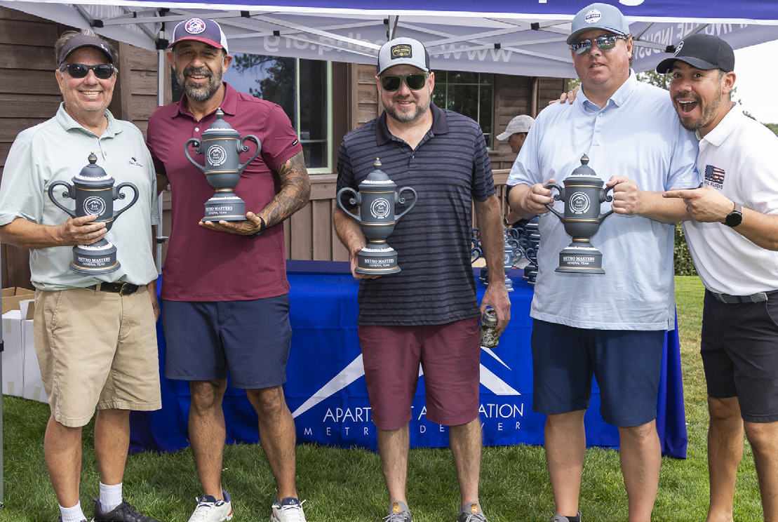 Perfect Clean Property Services team members pose with their trophies.