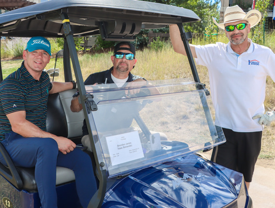 North West Roofing representatives beside a golf cart