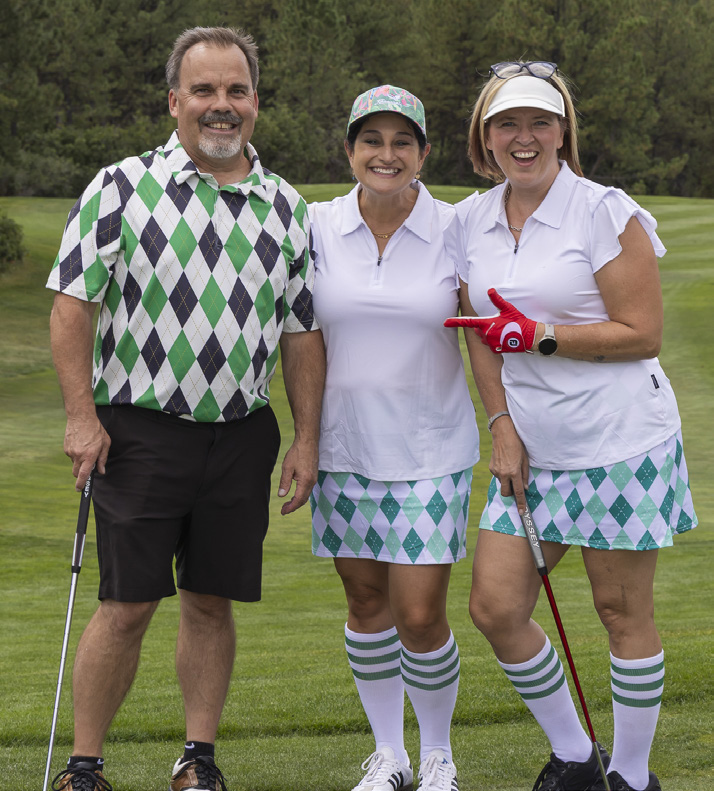 Tom Brown, Andrea Michels and Amy Lassers posing on the golf course